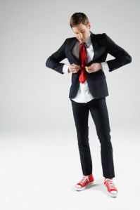 Businessman trying to button suit that is too small for him