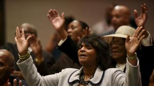 Members of the community pray during Sunday morning worship at New Shiloh Baptist Church, where Freddie Gray's April 27 funeral service was held in Baltimore